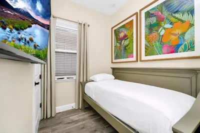 a bedroom with a bed and paintings on the wall at Coral Cottage With Private Pool Near Disney With Margaritaville Resort And Island H20 Waterpark Access - 2946Sr in Orlando