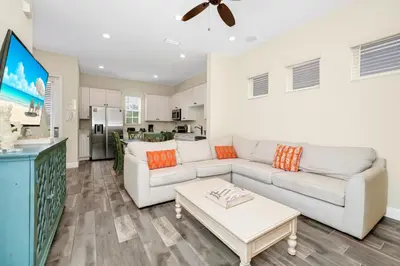 a living room with a couch and a table at Coral Cottage With Private Pool Near Disney With Margaritaville Resort And Island H20 Waterpark Access - 2946Sr in Orlando