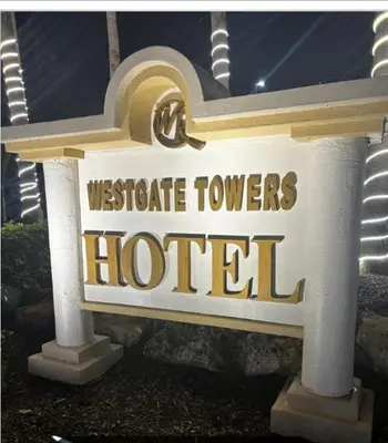 a sign for a westgate towers hotel with a car on it at Westgate Towers in Orlando