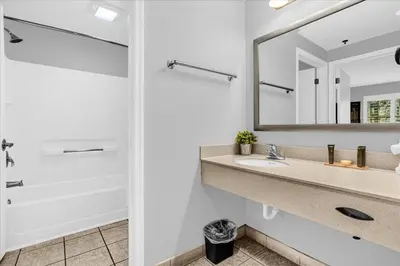 a bathroom with a sink and a mirror at Condo w Swimming Pool Near Universal Studios in Orlando