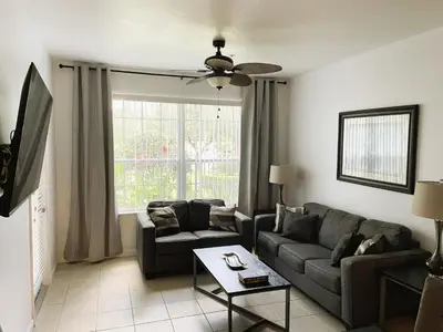 a living room with a couch and a table at Family Friendly II in Orlando
