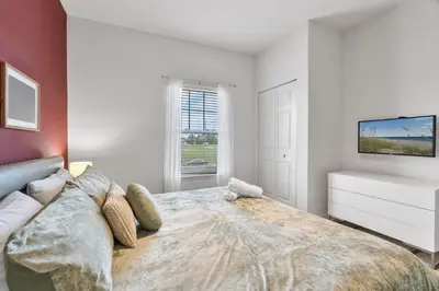 a bedroom with a large bed and a tv at Amzing location 3BDR House - 8980 in Kissimmee