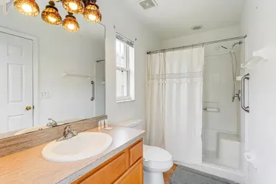 a bathroom with a sink and a toilet and a shower at 3 Mi to Disney World Poolside Oasis with Game Room in Kissimmee