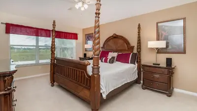a bedroom with a bed and a dresser and a window at Windsor Palms Resort Vacation Home in Kissimmee
