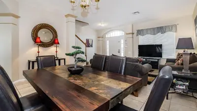 a living room with a wooden table and chairs at Windsor Palms Resort Vacation Home in Kissimmee