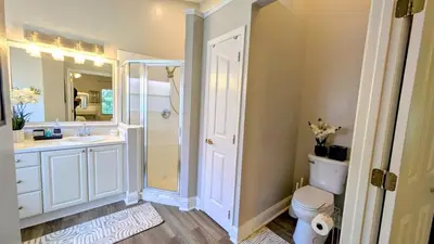 a bathroom with a toilet and a sink and a shower at Modern 3BR Home 10 Min from MCO in Orlando