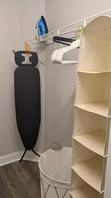 a closet with a black organizer and shelves at Modern 3BR Home 10 Min from MCO in Orlando