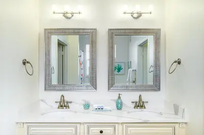 a bathroom with two sinks and two mirrors at 4862 Cayview Avenue 408 in Orlando