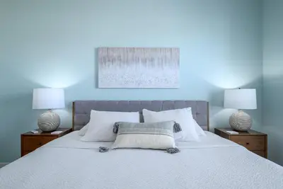 a bedroom with a white bed with two lamps at 4862 Cayview Avenue 408 in Orlando