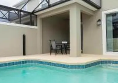 a swimming pool in front of a house with a patio at 4243 PA - Storey Lake Escape 4BR Pool Home Near Disney in Kissimmee