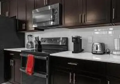 a kitchen with a stove and a microwave at 4243 PA - Storey Lake Escape 4BR Pool Home Near Disney in Kissimmee
