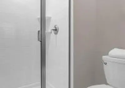 a glass shower door with a toilet in a bathroom at 4243 PA - Storey Lake Escape 4BR Pool Home Near Disney in Kissimmee