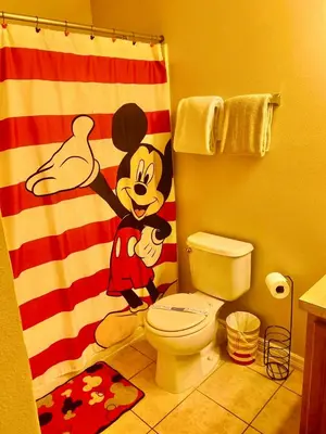 a bathroom with a mickey mouse shower curtain at Paraíso Magico Getaway 5152 in Kissimmee
