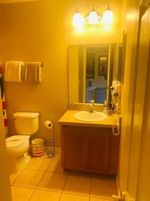 a bathroom with a sink and a toilet and a mirror at Paraíso Magico Getaway 5152 in Kissimmee