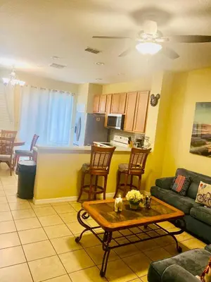 a living room with a couch and a table at Paraíso Magico Getaway 5152 in Kissimmee
