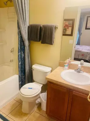 a bathroom with a toilet and a sink at Paraíso Magico Getaway 5152 in Kissimmee