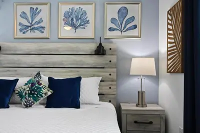 a bedroom with a bed with a wooden headboard at 2900SS SL Family Lakeview Escape Disney-Themed Fun 8 Mins to Parks in Kissimmee