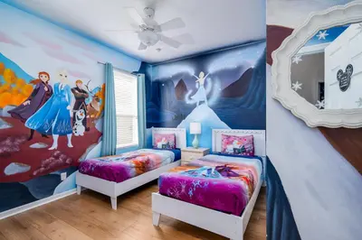 a bedroom with two beds and a disney mural at Free Waterpark|Game Room|Near Dis! in Orlando