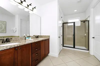 a bathroom with two sinks and a large mirror at Spacious Home With Private Pool And Game Room Near Disney With Waterpark Access At Encore Resorts Reunion - 390La in Orlando