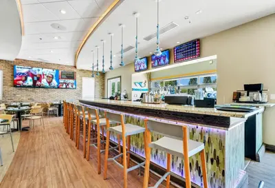 a bar in a restaurant with chairs and tables at Spacious Home With Private Pool And Game Room Near Disney With Waterpark Access At Encore Resorts Reunion - 390La in Orlando