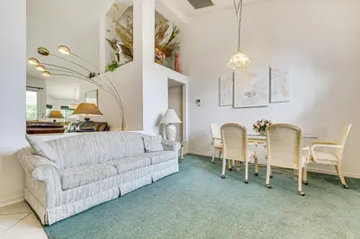 a living room with a couch and a table at 12 Mi to Disney Secluded Family Home with Pool in Kissimmee