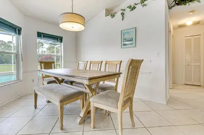 a dining room with a wooden table and chairs at 12 Mi to Disney Secluded Family Home with Pool in Kissimmee