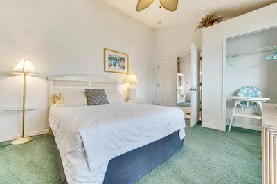 a bedroom with a large bed with a white bedspread at 12 Mi to Disney Secluded Family Home with Pool in Kissimmee