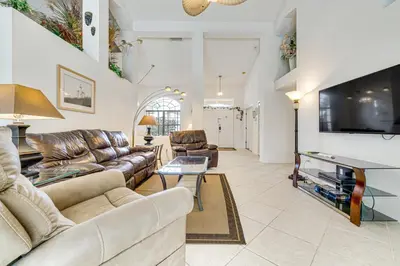 a living room with couches and a flat screen tv at 12 Mi to Disney Secluded Family Home with Pool in Kissimmee