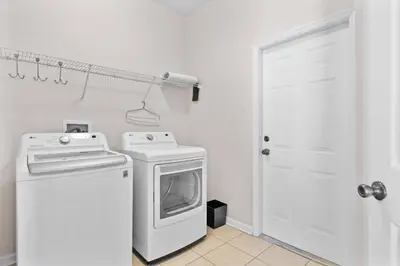 a kitchen with a stove and a washing machine at Large house at Windsor Hills Resort in Orlando