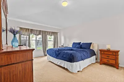 a bedroom with a bed and a dresser and a window at Large house at Windsor Hills Resort in Orlando