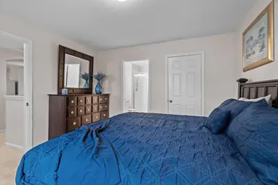 a bedroom with a blue bed and a dresser at Large house at Windsor Hills Resort in Orlando
