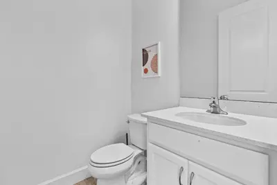 a white bathroom with a toilet and a sink at Brand NEW 11 Bedrooms At Sonoma in Kissimmee