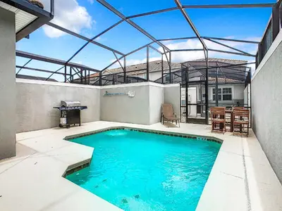 a swimming pool in the middle of a house at Amazing 5BR Townhouse near Disney - Private Pool in Kissimmee