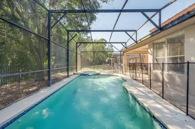 an indoor swimming pool in the backyard of a house at The Hearth Home - 4 Suites in Kissimmee