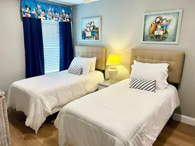 two beds in a small room with two at The Palms 1st floor By Pool, Fully Stocked 5 stars in Kissimmee