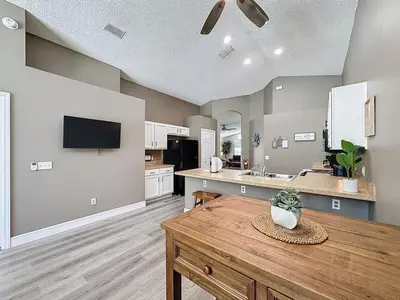 a large kitchen with a wooden table in a room at Terra Verde Resort 4 Bed Pool Spa Villa villa in Kissimmee