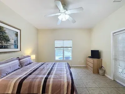 a bedroom with a bed and a ceiling fan at Walk to Silver Spurs Rodeo and Heritage Park home in Kissimmee