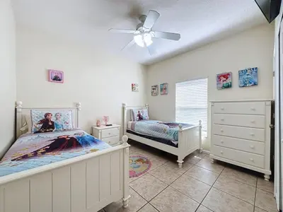 a bedroom with two beds and a ceiling fan at Walk to Silver Spurs Rodeo and Heritage Park home in Kissimmee