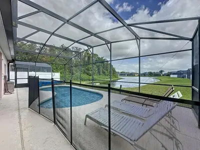 a glass house with a view of a swimming pool at Walk to Silver Spurs Rodeo and Heritage Park home in Kissimmee