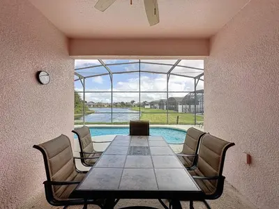 a dining room with a table and chairs and a pool at Walk to Silver Spurs Rodeo and Heritage Park home in Kissimmee