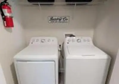 two white machines in a room with a fire extinguisher at 4826 LL - Storey Lake Dream 4BR Pool Home Near Disney in Kissimmee