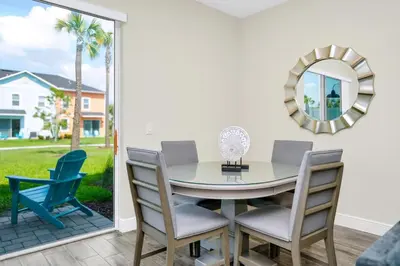 a dining room with a table and chairs and a mirror at Blue Sky Hideaway Villa Near Disney With Margaritaville Resort & Island H20 Waterpark Access - 2921Cs in Orlando