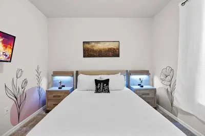 a bedroom with a large bed with two night stands at Brand New 05 Bedrooms At Windsor Cay in Orlando