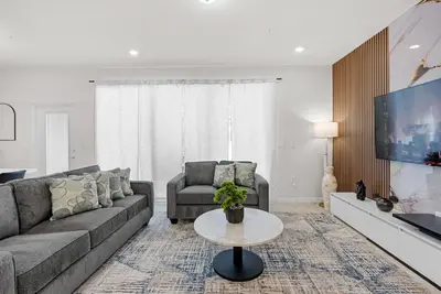 a living room with a couch and a tv at Brand New 05 Bedrooms At Windsor Cay in Orlando