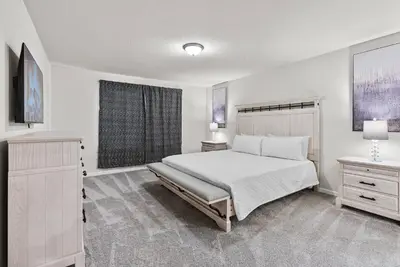 a white bedroom with a bed and a window at Brand New 05 Bedrooms At Windsor Cay in Orlando