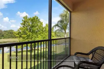 a balcony with a bench and a view of a golf course at Charming 3-Bedroom Home in Gated Oakwater Resort in Orlando
