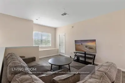 a living room with a couch and a table at Charming 3-Bedroom Home in Gated Oakwater Resort in Orlando