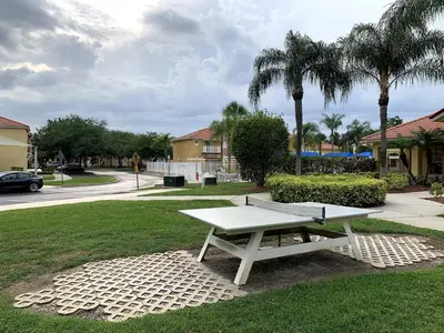 a white picnic table sitting in a park at Cozy Kissimmee Hideaway in Kissimmee