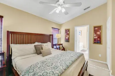 a bedroom with a bed with a ceiling fan at Private Pool Villa, 3mi to Disney with Game Room in Kissimmee