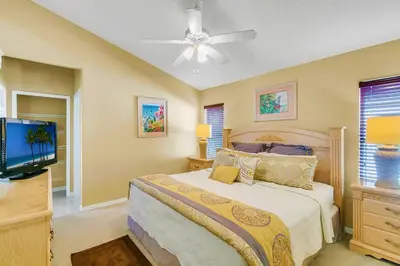 a bedroom with a bed and a flat screen tv at Private Pool Villa, 3mi to Disney with Game Room in Kissimmee
